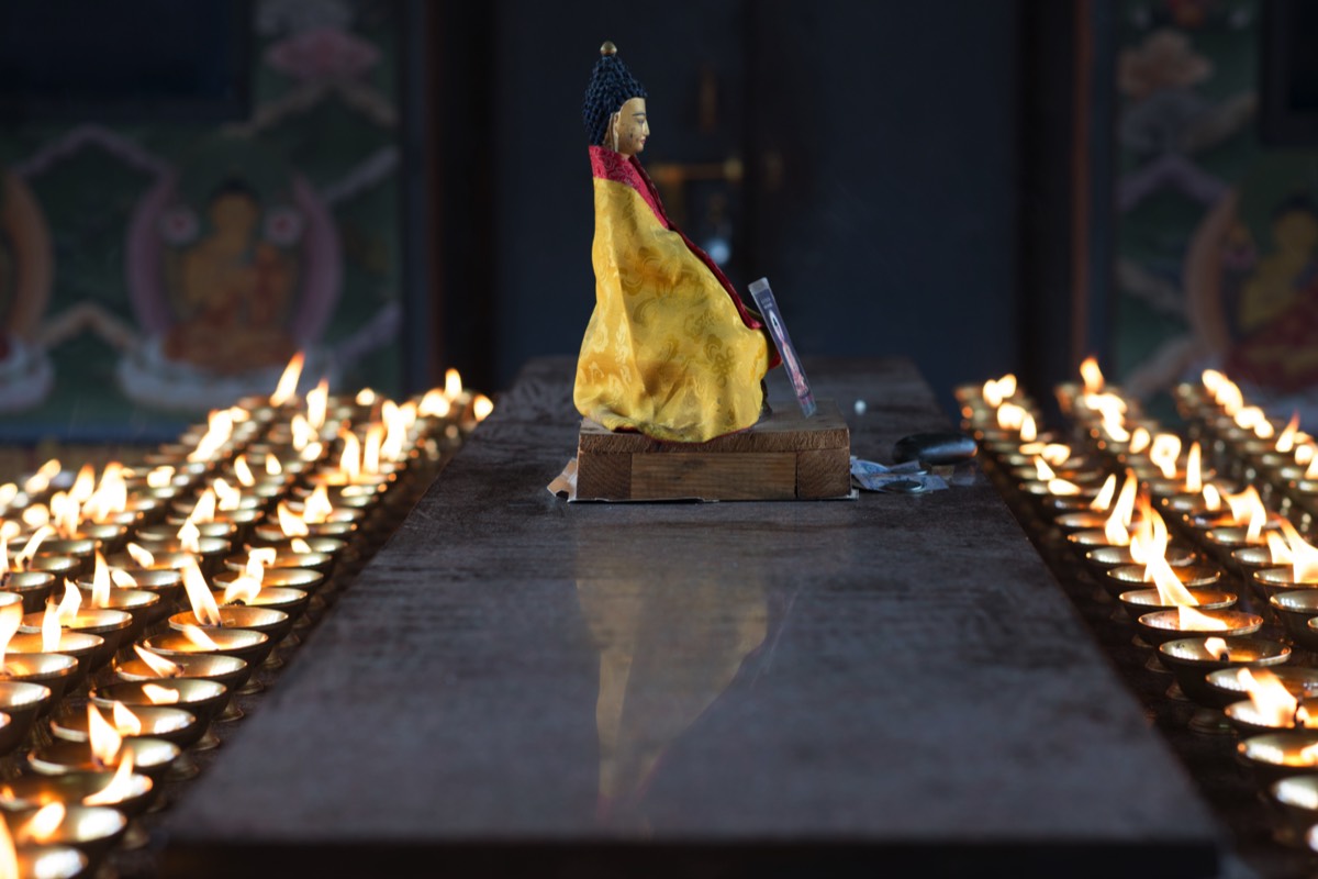 Butter lamps in a small temple next to Druk Wangyal Khang Zhang Chortens 